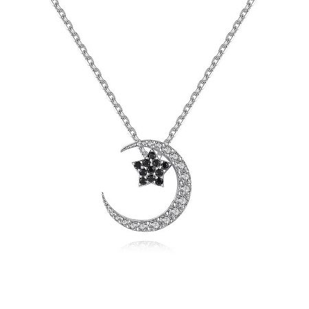 Close-up of the silver crescent moon and star pendant with white and black cubic zirconia.