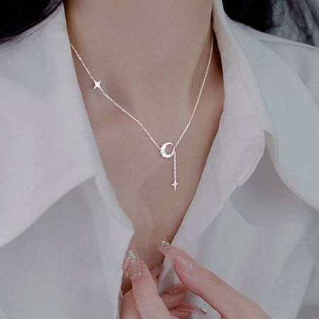 Model wearing the 925 silver crescent moon and star necklace, showcasing its length.