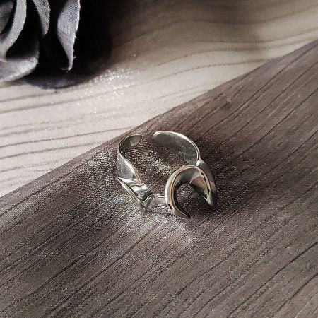 Close-up of an abstract silver adjustable ring with a crescent design from the wholesale set.