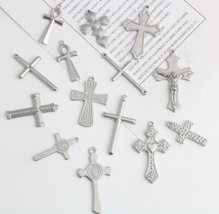 A collection of various custom silver cross pendants, showcasing different styles and finishes.
