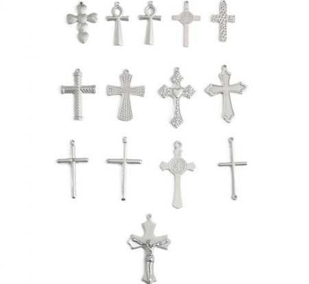 An assortment of intricately designed silver cross pendants, highlighting different finishes.