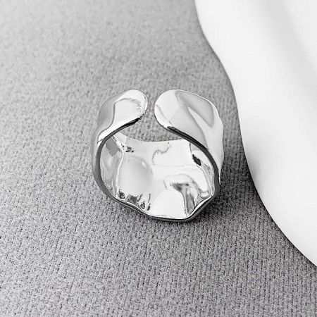 Side profile of a silver wide band open ring, highlighting its hammered finish.