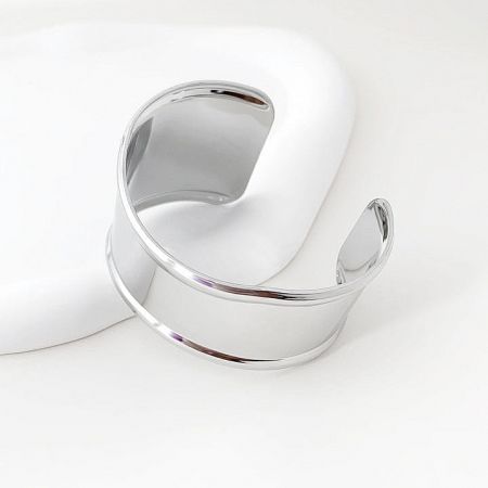 Close-up of the sleek silver punk cuff bracelet, showcasing its polished finish.