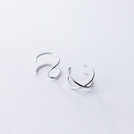 Clean product shot of the pair of 925 sterling silver curved cuff earrings.