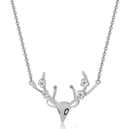 Detailed shot of the delicate deer antler necklace pendant, showing the black epoxy eye accents and rhodium plating.