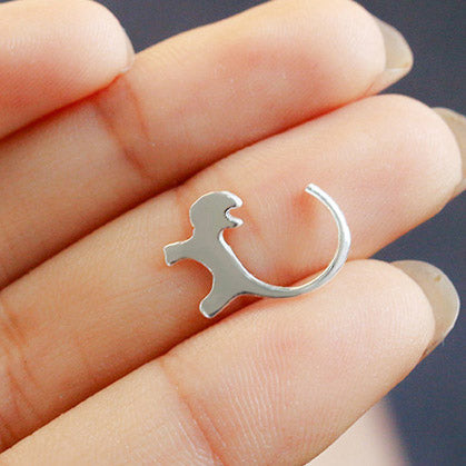 A unique silver dinosaur-shaped earring.