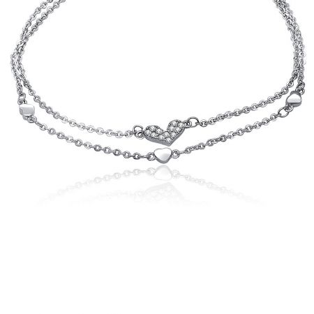 Detailed view of the heart charm with pave-set cubic zirconia on the double chain bracelet.