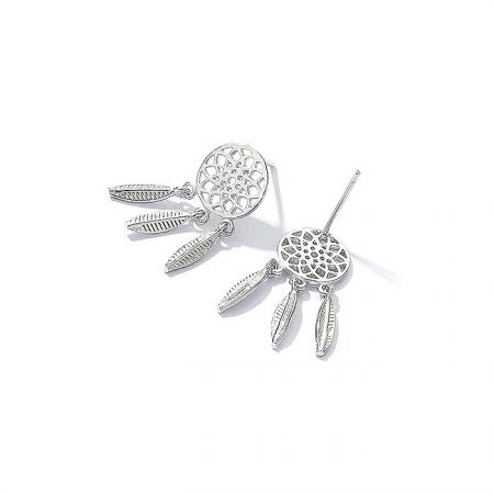 Detailed shot of the silver dreamcatcher-style earrings highlighting the polished finish and feather charms.