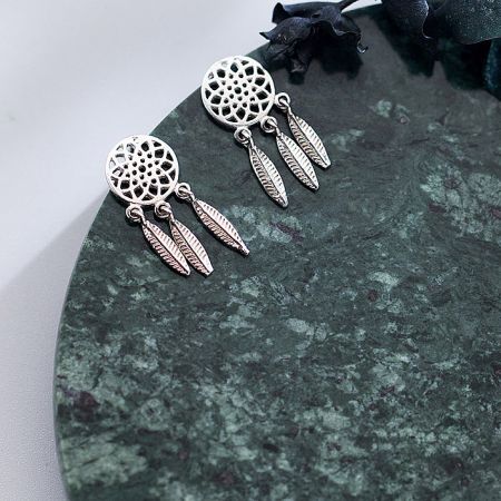 Front view of the pair of silver dreamcatcher earrings against a white background.