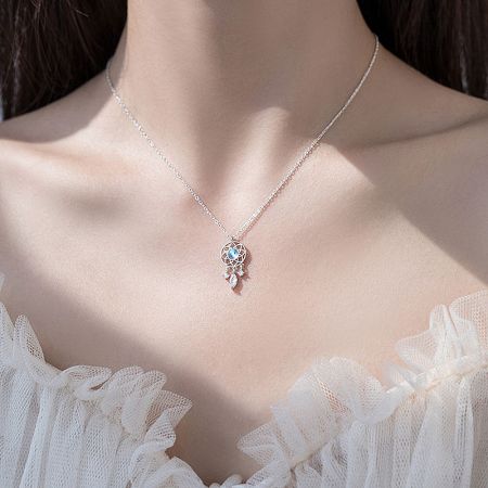 Side view of the dreamcatcher necklace on a model, showing how it lays.