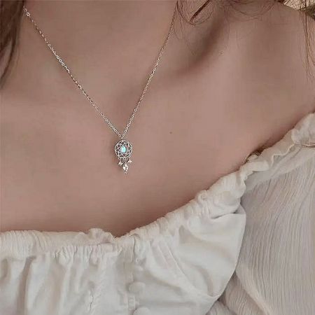 Model wearing the silver dreamcatcher necklace to showcase its length and style.