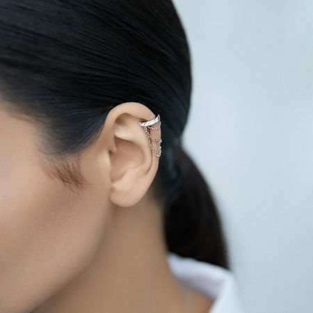 Model showcasing the sterling silver chain ear cuff, highlighting its elegant drape and comfortable fit on the ear.