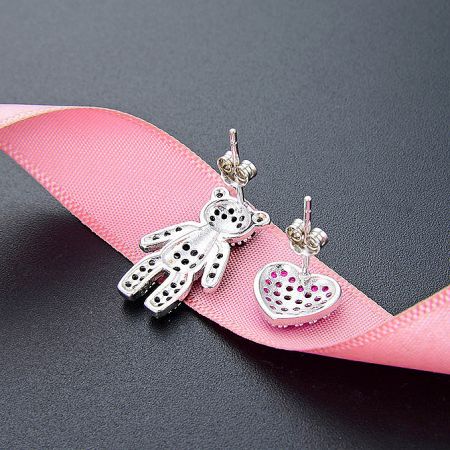 A delicate silver dragonfly stud and a pink heart stud earring, part of the 5-pair set.