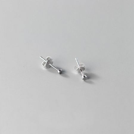 Close-up of the 925 silver tiny circle stud earrings in a silver finish.