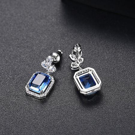 Side view of the Vitrail Light Stone earrings showing the silver metal post-back closure and blue gemstones.