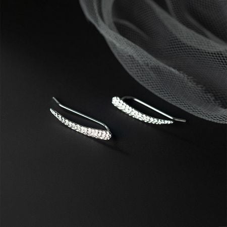 Elegant curved sterling silver ear cuff adorned with sparkling clear gemstones.
