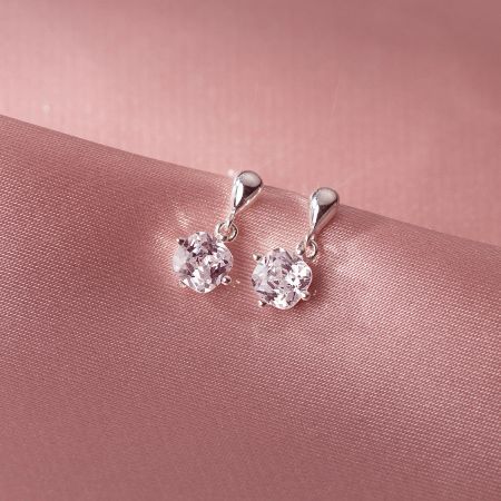 A pair of sterling silver cubic zirconia earrings displayed for wholesale.