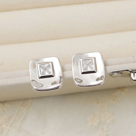 Silver Plated Square CZ Cubic Zirconia Ear Post Stud Earrings (5 Pairs) - A close-up view of a pair of silver-plated square stud earrings, each featuring a sparkling cubic zirconia stone, displayed on a neutral background.