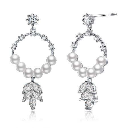 Close-up of the silver chandelier earrings with white pearls and teardrop-shaped crystal pendants, highlighting the craftsmanship.