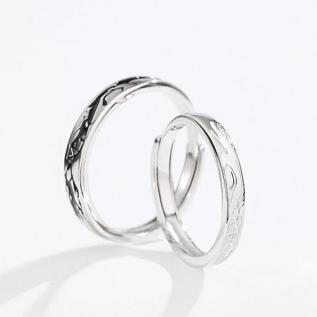 Detailed view of the engraved patterns on the sterling silver couple rings.