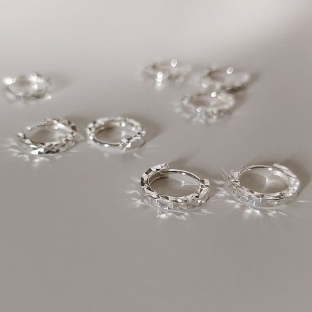 925 Sterling Silver Diamond Cut Hook Earrings - A pair of 925 Sterling Silver Diamond Cut Hook Earrings showcasing their intricate faceted texture on a white background.