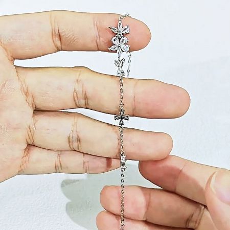 Close-up of the secure and stylish cross-shaped clasp on the sakura flower bracelet.