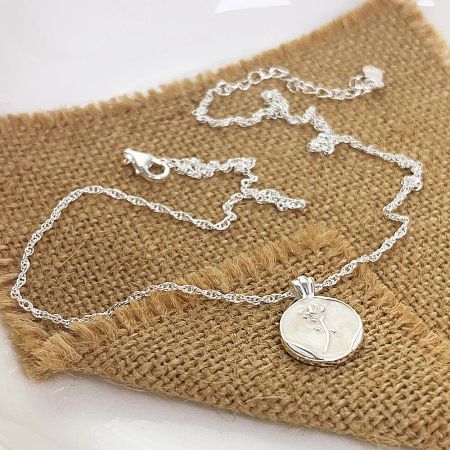 A sterling silver necklace with a delicate floral pendant, part of the wholesale set.