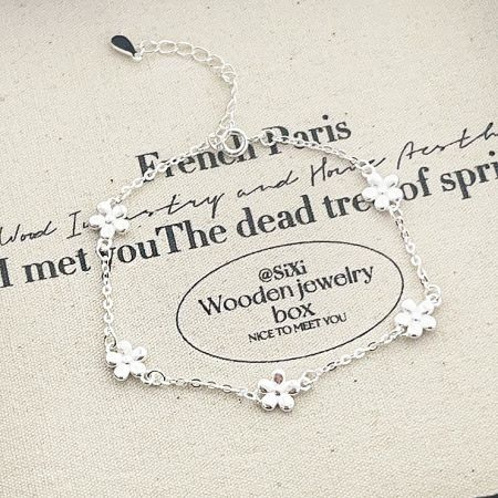 The 925 silver flower charm bracelet displayed on a JR Fashion Accessories branded pouch.