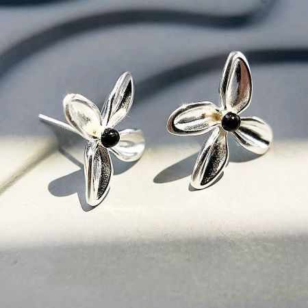 Another angle of the simple black onyx flower stud earrings, showcasing their polished finish.