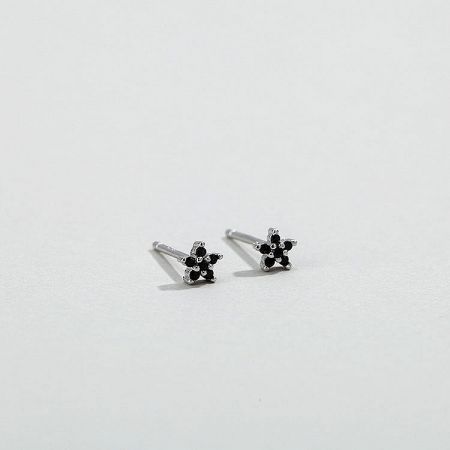 Elegant silver flower stud earrings with striking black zirconia centers.