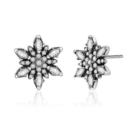 Close-up detail of the silver flower earrings highlighting the sparkling diamond-like clusters.