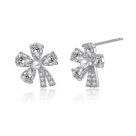 Side profile of the silver flower stud earrings, highlighting the pearl center and intricate gemstone details.