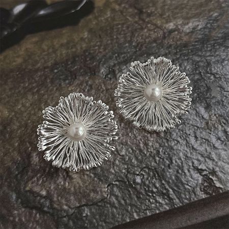 Statement Floral Earrings with Pearl Center in Brass - Wholesale - A pair of statement floral earrings crafted from silver-toned brass, each featuring an intricate petal design with a lustrous pearl at the center.