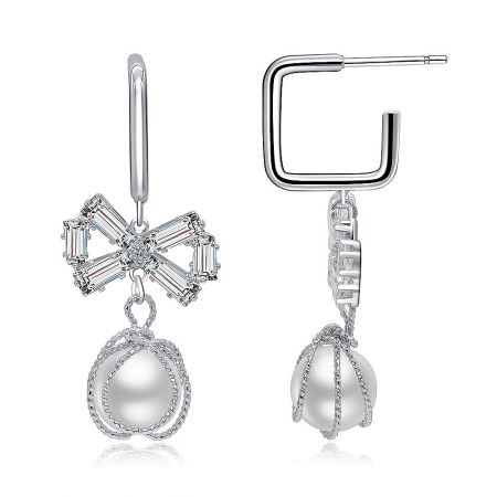 Side view of the Chic Bow Pearl Hook Earrings showing the U-shaped post and the large white pearl.
