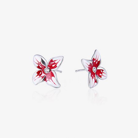 Detailed view of the red and white enamel flower stud earrings in sterling silver.