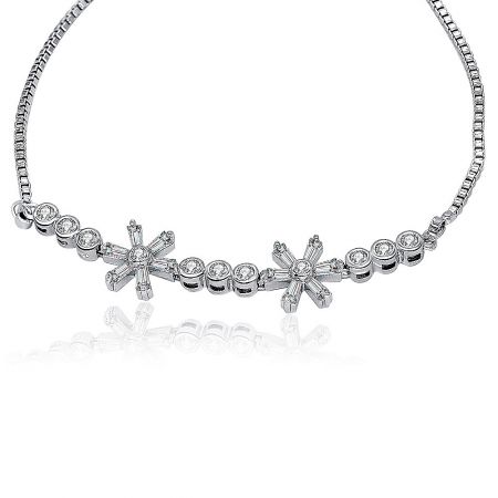 Detailed view of the CZ flower charms on the box chain bracelet, highlighting the bezel-set round cubic zirconia stones.