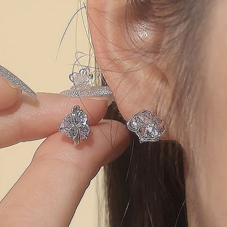 A pair of the 925 sterling silver hug heart earrings, highlighting their sparkling finish.