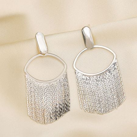 Detailed studio shot of the silver plated tassel earrings.