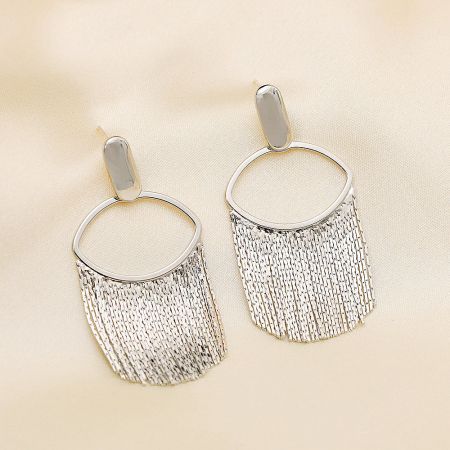 Close-up view of the silver fringe earring's oval hoop and chain detail.