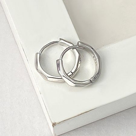Detailed view of the silver octagon huggie hoop earring showcasing its geometric shape.