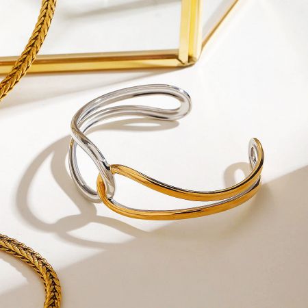 Two Tone Gold and Silver Bangles Dark Feminine Style Stainless Steel Bracelets Set of 5 - A minimalist two-tone stainless steel bangle in gold and silver with an elegant intertwined design, representing a dark feminine style.