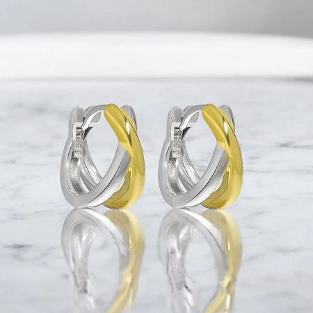 Detailed studio shot of the 925 sterling silver two-tone knot hoop earrings, focusing on the craftsmanship of the intertwined design.