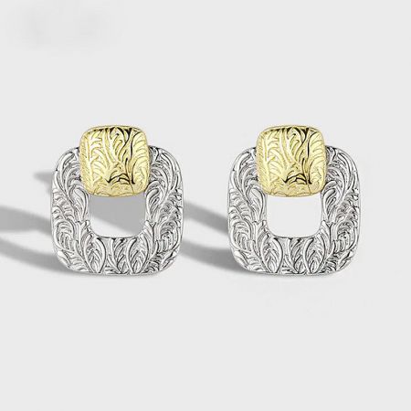 A pair of 925 sterling silver square stud earrings with intricate gold and silver patterns.