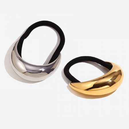 Close-up of the sleek, curved design of the gold and silver metallic hair tie cuffs.