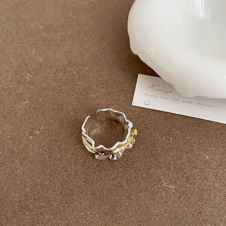 Detailed view of the brass gold and silver plated bow ring, highlighting its unique design.