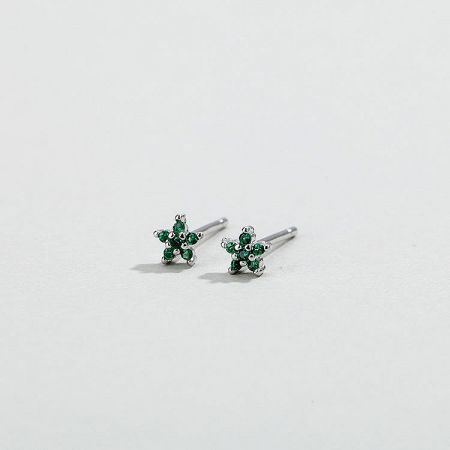Close-up of silver flower stud earrings with green zirconia stones.