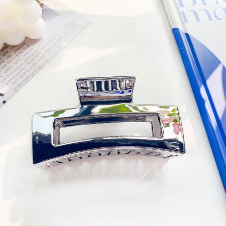 A sturdy silver metal hair clip with a modern aesthetic.