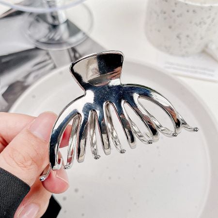 Detailed product image of the silver metal pumpkin-shaped anti-slip hair clip.