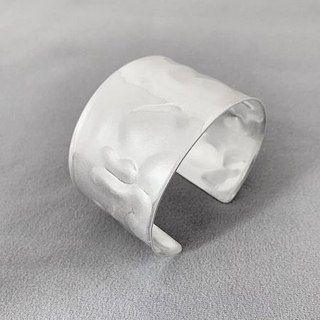 Detailed view of the silver hammered cuff bracelet, highlighting its unique texture.