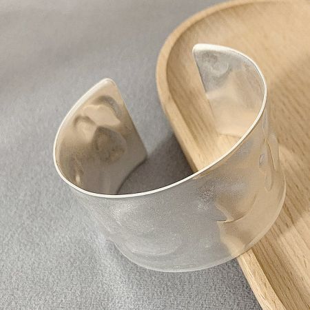 Product shot of the silver hammered cuff bracelet on a white background.